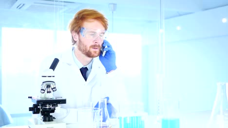 Scientist-Talking-on-Phone-in-Laboratory