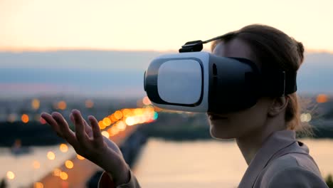 Frau-nutzt-virtual-Reality-Brille-in-der-Stadt-nach-Sonnenuntergang