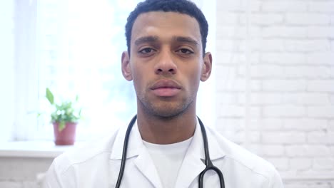 Serious-African-American-Doctor-Looking-at-Camera-in-Clinic