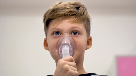 School-boy-sitting-with-Inhalation-mask-on-his-face.