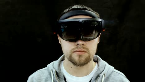 Augmented-Reality-Glasses.-Young-adult-Caucasian-man-using-holographic-augmented-reality-glasses.-Game-development