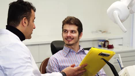 Young-man-having-medical-appointment-with-his-dentist