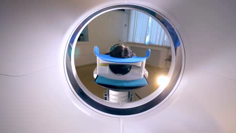 Young-adult-female-lying-inside-mri-during-medical-exam.