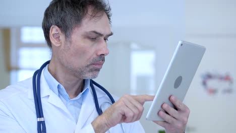 Doctor-using-Tablet-Pc-for-Online-Browsing