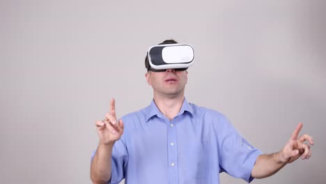 Man-wearing-virtual-reality-goggles-on-grey