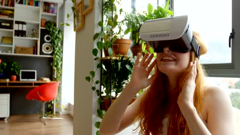 Woman-using-virtual-reality-headset-in-living-room-4k