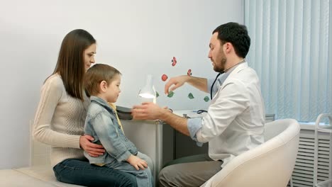 Doctor-measuring-blood-pressure-of-a-child-in-examination-room