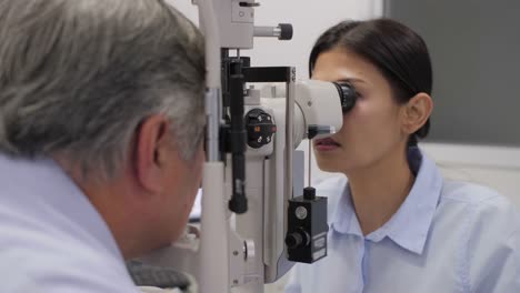 Doctor-checking-senior-patients-eyes