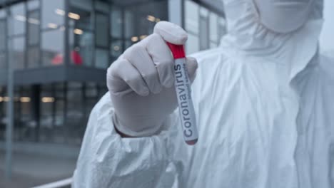 focus-pull-of-asian-scientist-holding-sample-with-coronavirus-lettering