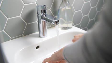 close-up-of-woman-washing-hands-with-liquid-soap