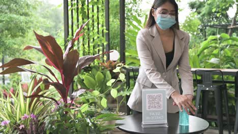 sanitizing-hand-and-qr-code-scan-before-entering-cafe