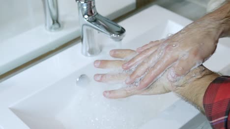 Washing-hands-with-proper-equipment-and-antibacterial-soap-on-the-background-of-running-water-in-the-bathroom.Rubbing-his-fingers,scraping-his-hands.Prevent-harmful-microbes-from-getting-into-your-hands