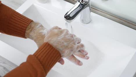 Washing-hands-rubbing-with-soap-man-for-corona-virus-prevention.A-young-man-takes-care-of-the-cleanliness-of-his-hands,close-up.