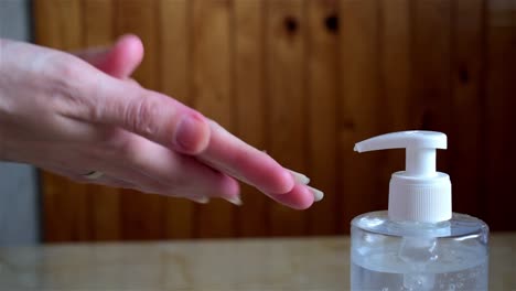 Close-up-of-female-hands-using-hand-sanitizer