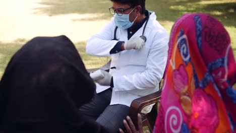 Medical-staff-doctors-outdoors-with-a-senior-female-in-rural-India