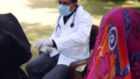 Medical-staff-doctors-outdoors-with-a-senior-female-in-rural-India