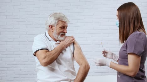 Enfermera-joven-con-mascarilla-protectora-en-la-cara-que-da-la-vacuna-covid-2019.