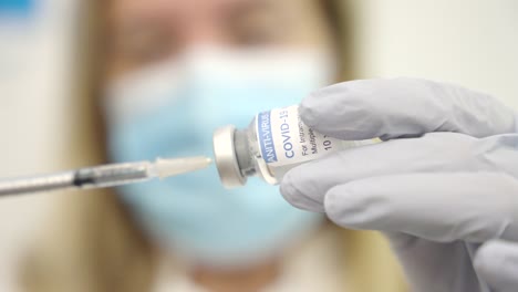 close-up-of-a-female-healthcare-worker-filling-a-syringe-with-a-covid-19-vaccine