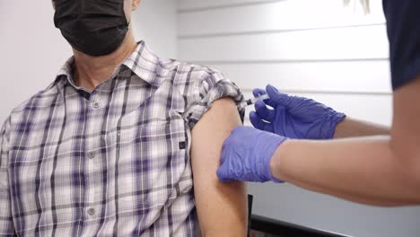 close-up-of-a--caucasian-man-being-vaccinated-in-the-shoulder