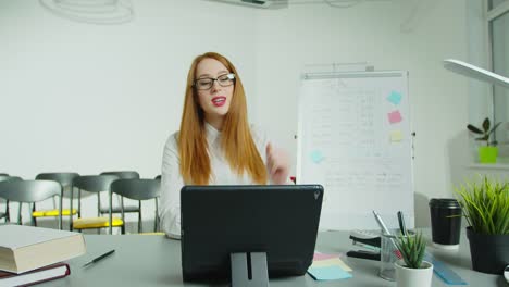 Woman-professor-sitting-at-table-and-lecturing-online-at-class.-Female-English-teacher-in-glasses-speaking-on-tabletPC-camera.-Education-concept.-Quarantine-concept.-Study-by-internet.