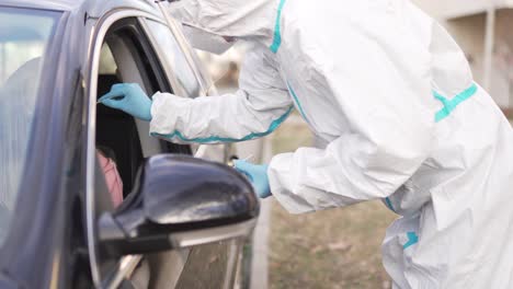 Healthcare-worker-doing-PCR-testing-on-Covid-19-from-patient-in-car