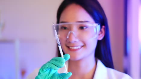 Close-up-of-asian-female-doctor-preparing-a-syringe-footage-.Coronavirus-vaccine.