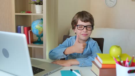 Child-Boy-Kid-schoolboy-in-glasses-using-tablet-laptop-computer-for-school-homework,-studying-at-home