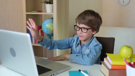 Child-Boy-Kid-schoolboy-in-glasses-using-tablet-laptop-computer-for-school-homework,-studying-at-home