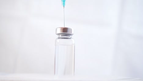 Close-up-of-a-Syringe-with-a-Needle-Drawing-a-Medicine-from-a-Glass-Vial