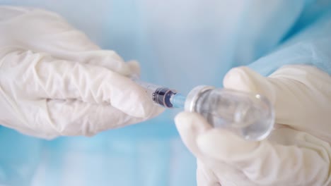 Close-up-of-Hands-in-Medical-Gloves-Filling-a-Syringe-with-Medication