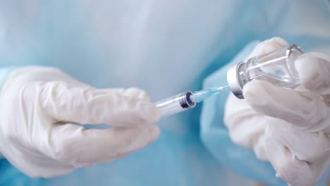 Close-up-of-Hands-in-Medical-Gloves-Filling-a-Syringe-with-Medication