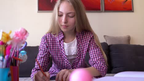 Girl-writing-her-homework-assignment-at-home