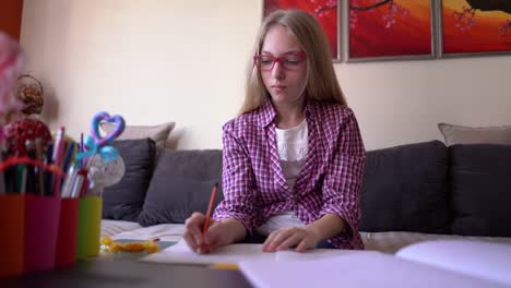 Girl-writing-her-homework-assignment-at-home