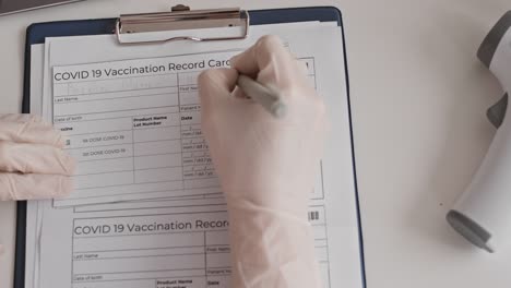 Hand-Filling-in-Vaccination-Record-Card