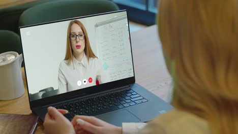 Woman-studying-at-home-office-online-by-conference-video-call-laptop-speak-communicates-teacher.-Female-student-makes-conference-video-call-on-laptop-computer-talks-with-web-tutor,-online-teacher-in-remote-webcam-chat-on-screen.