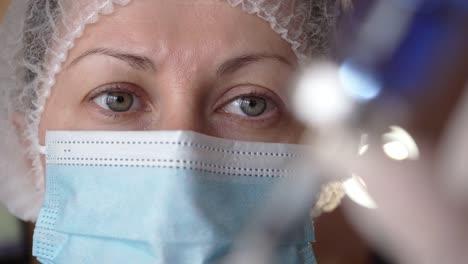 Close-up-Portrait-of-Doctor-in-Medical-Mask-Filling-Syringe-with-Vaccine