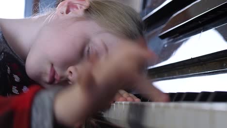 Attractive-child-study-music-melody-on-piano-lesson