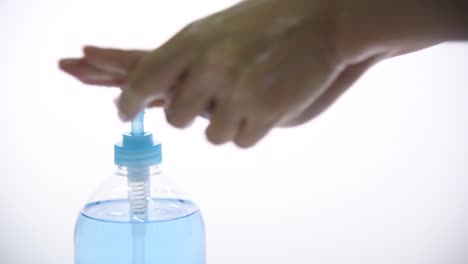 Woman-clean-hands-with-hand-sanitizer-on-white-background