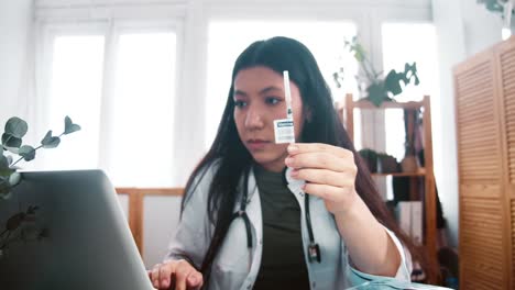 Vaccine-trial-inspection.-Zoom-in-on-professional-multiethnic-virologist-doctor-woman-in-lab-coat-look-at-syringe-cure.