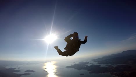 Skydiver-having-fun-above-the-sea-&-mountains-4K