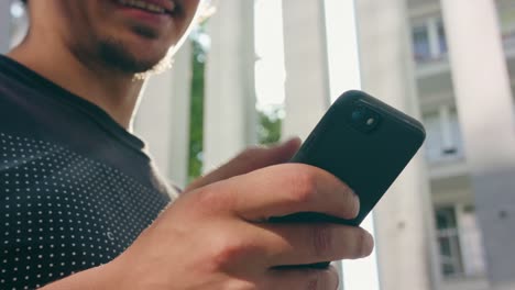 Young-Man-Using-Phone-Outdoors