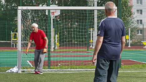 Elderly-Men-Playing-Football-Outdoors