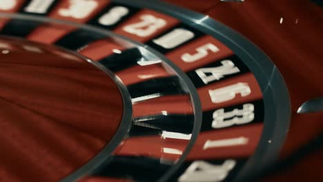 Wooden-roulette-wheel-with-black-and-red-sectors.-Close-up-white-ball-stopped