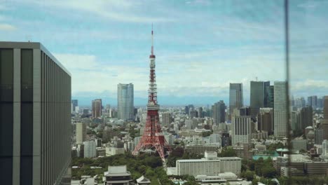 Beautiful-revealing-shot-of-a-Tokyo-tower-surrounded-with-skyscrapers-on-a-summer-day.