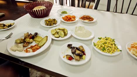 Timelapse-of-man-eating-Arabic-food,-Hummus-and-salads-in-a-restaurant