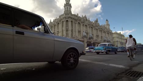 Old-classic-American-cars-passing-on-the-streets-of-Havana-city,-Cuba