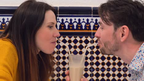 Loving-couple-drinking-horchata-from-one-glass