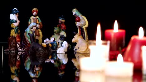 Christmas-nativity-scene-with-candles-on-black