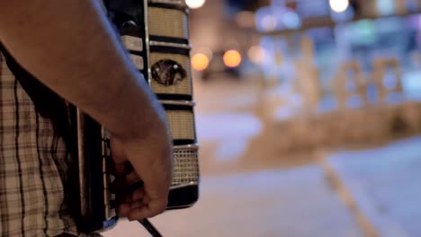 Man-playing-accordion-in-the-street-and-earning-money