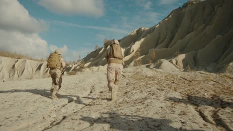 Follow-Shot-of-Squad-of-Soldiers-Running-Forward-During-Military-Operation-in-the-Desert.